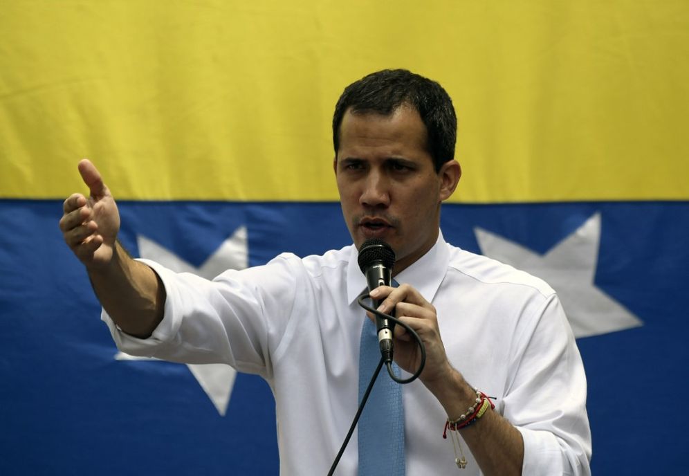 Venezuelan opposition leader Juan Guaido addresses supporters during a street meeting within a demonstration heading to the National Assembly, in Las Mercedes, east Caracas on March 10, 2020.