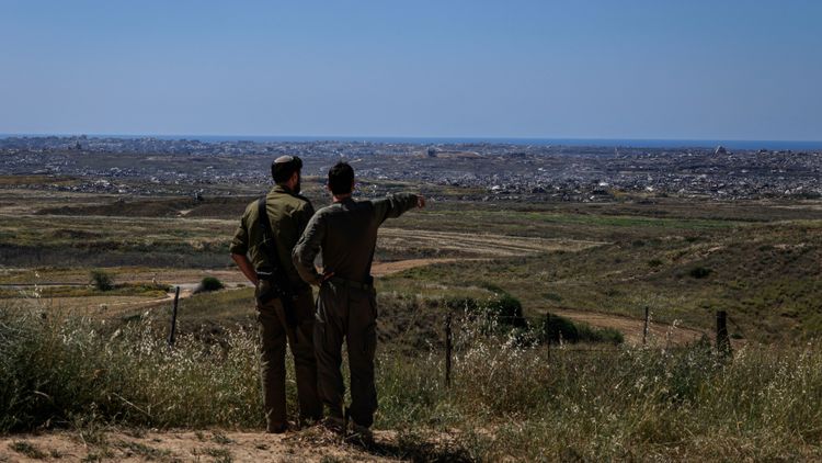 Israeli soldiers look toward the northern Gaza Strip from an observation point near the Israeli border, April 21, 2026. 
