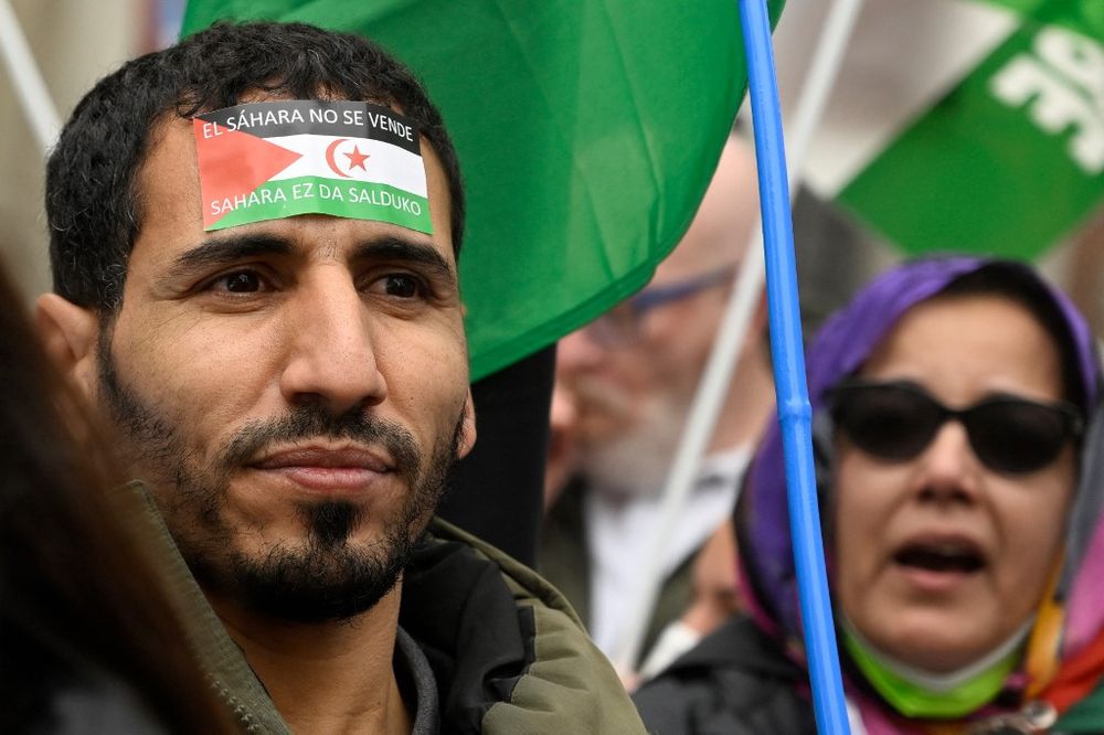 A demonstrator wears a label on his forehead depicting a Western Sahara flag during a protest against the Spanish government support for Morocco's autonomy plan for Western Sahara, in Madrid, on March 26, 2022.