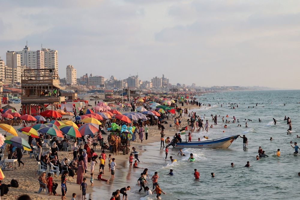 People gather at the beach, along the shore of Gaza City, Gaza Strip, on June 13, 2022.
