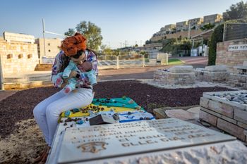 Chaim Goldberg/FLASH90 Widow Revital Shamir visits the grave of her late husband Mordechai Shamir, together with her 4-year-old son Lavi and newborn baby girl Ori at the military cemetery in Elkana, Israel