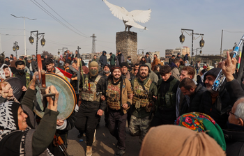 Kurdish fighters with the Syrian Democratic Forces (SDF) are cheered by local residents ahead of the end of a four-day truce with the Syrian government in Hassakeh, northeastern Syria, Saturday, Jan. 24, 2026. 