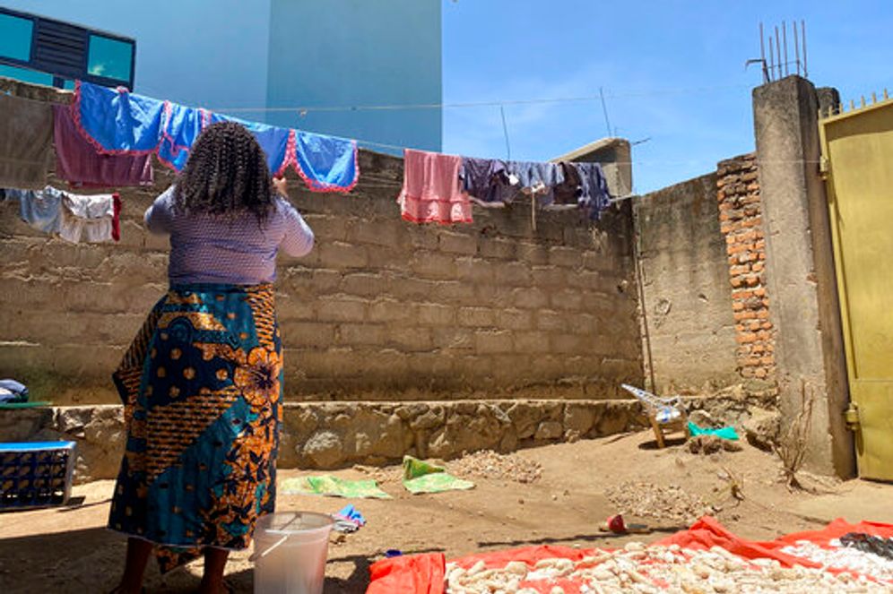 A woman hangs laundry outside her home in Beni, eastern DR Congo, on May 1, 2021.