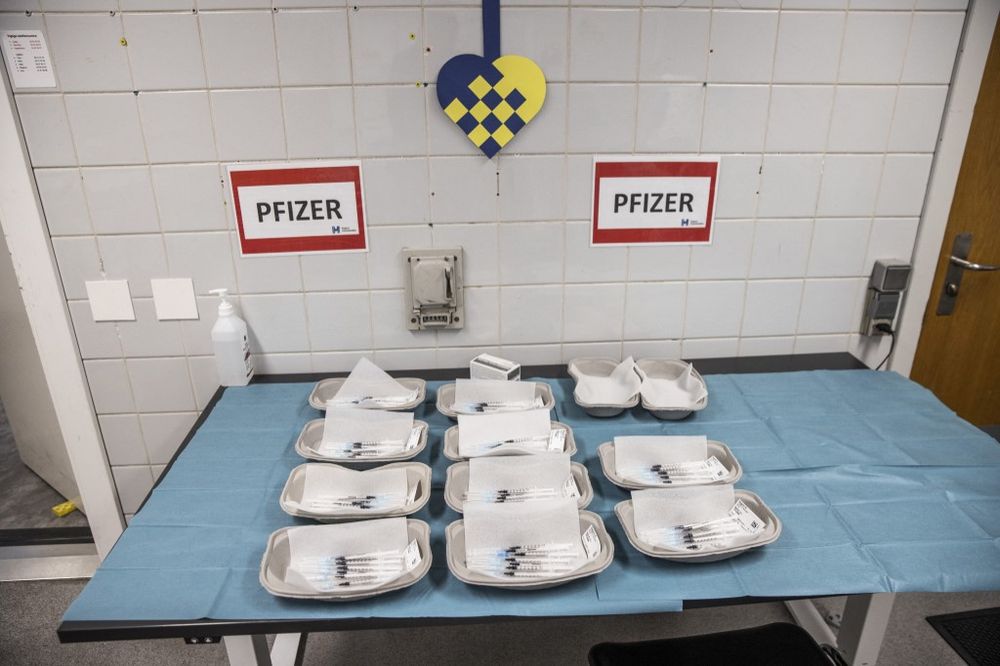 Paper trays containing syringes with the vaccine against the novel coronavirus are pictured on November 28, 2021 at a vaccination center in Amagar, Denmark.