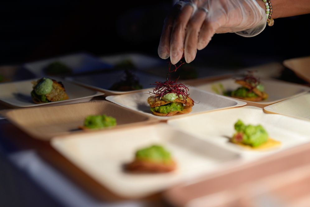 Olga Leon garnishes tostadas made with "lab-grown" chicken at a pop-up tasting hosted by California-based producer Upside Foods, Thursday, June 27, 2024, in Miami
