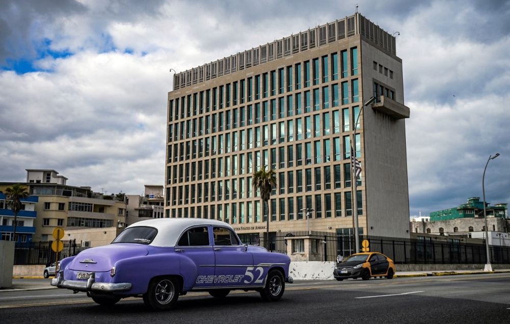 An old American car passes by the US embassy in Havana, Cuba, on May 3, 2022.