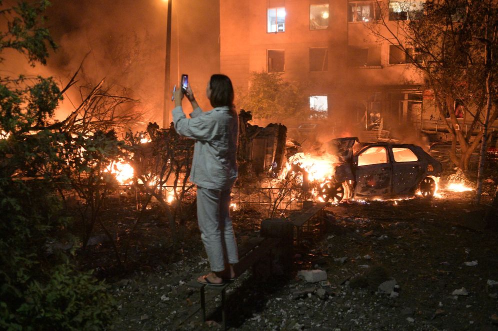 AP/Danylo Antoniuk A woman takes photo of destructions following Russian missile attacks in Kyiv, Ukraine, Monday, July 6, 2026.