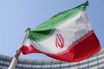 FILE - The Iranian national flag flies during a special session of an IAEA Board of Governors meeting in Vienna, Austria, March 2, 2026