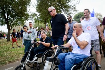 Israel's Defense Minister Benny Gantz (C), Israeli soldiers, Israeli veterans, and disabled soldiers march in Tel Aviv, Israel, on November 17, 2021.