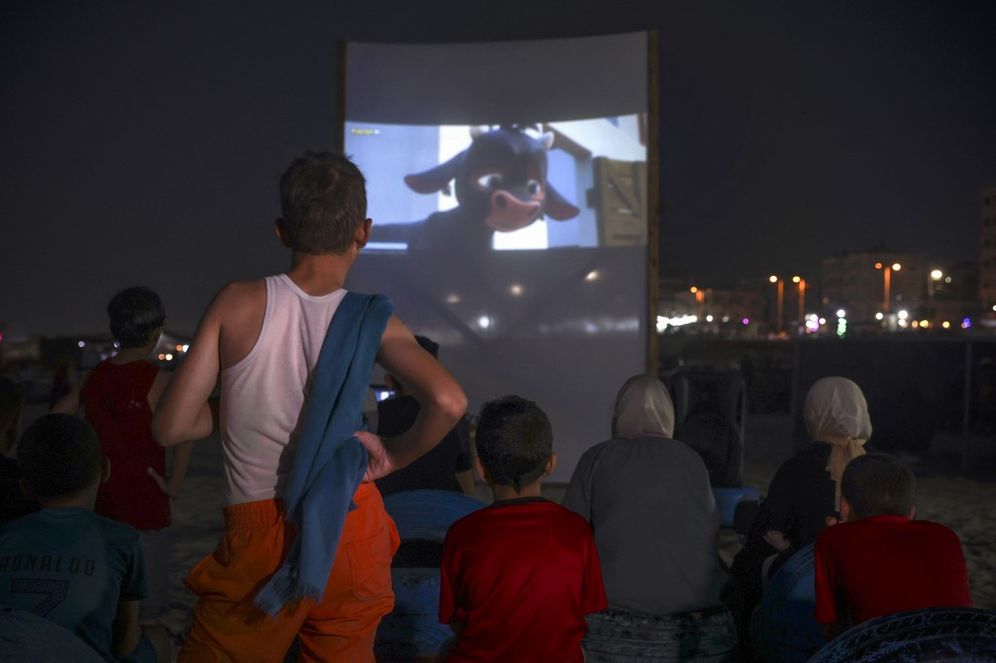 Palestinian children watch a movie at a pop-up open-air cinema at the beach in Gaza City, Gaza.