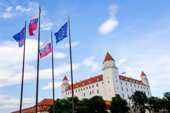 Slovak and EU flags blow in the wind near the Bratislava castle in Bratislava, Slovakia, June 30, 2016.