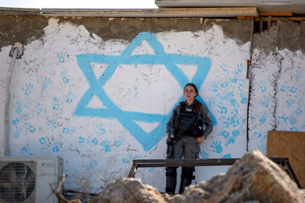 An Israeli border police officer stands guard at an evacuated Israeli settler outpost in the West Bank village of Beita, east of Nablus, October 10, 2021.
