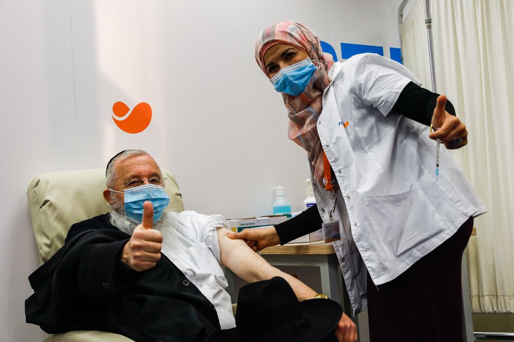 An Israeli man receives a Covid-19 vaccine, at Meuhedet Covid-19 vaccination center in Jerusalem, on December 21, 2020