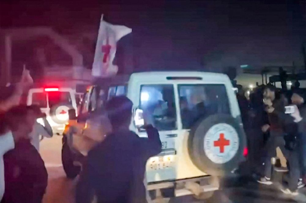 International Red Cross vehicles carrying hostages released by Hamas crossing the Rafah border point in the Gaza Strip.