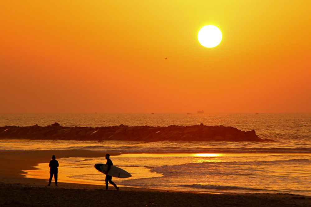 People enjoy during the sunset at the beach in Ashkelon, Israel.