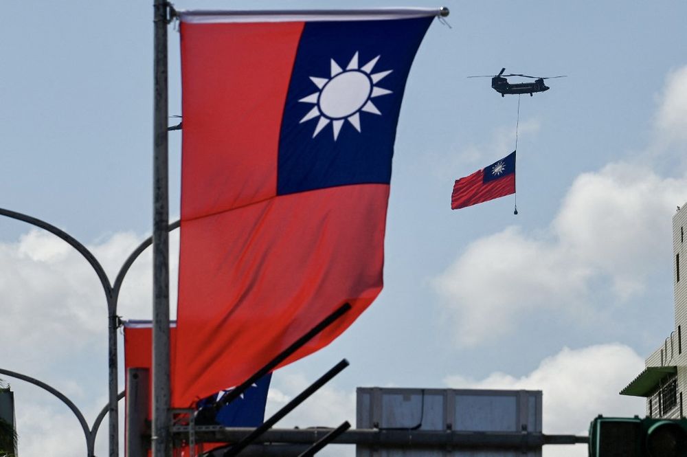 A helicopter carries a Taiwan flag during national day celebrations in Taipei, Taiwan, on October 10, 2021.