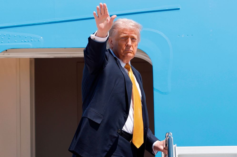 President Donald Trump waves from the stairs of Air Force One as he boards upon his arrival at Joint Base Andrews, Md., Tuesday, May 12, 2026, for a trip to China to meet President Xi Jinping. 