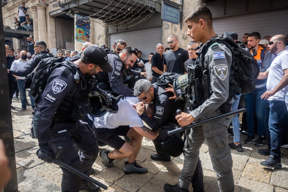 Israeli border police arrest a man in Jerusalem's Old City, ahead of the funeral of  Al Jazeera journalist Shireen Abu Aqleh, May 13, 2022.