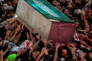 (AP Photo/Khalil Hamra) The coffin of the late Iranian Supreme Leader Ayatollah Ali Khamenei is carried through a crowd as mourners jostle to reach and touch it outside the Imam Hussein Shrine in Karbala, Iraq, early Thursday, July 9, 2026.