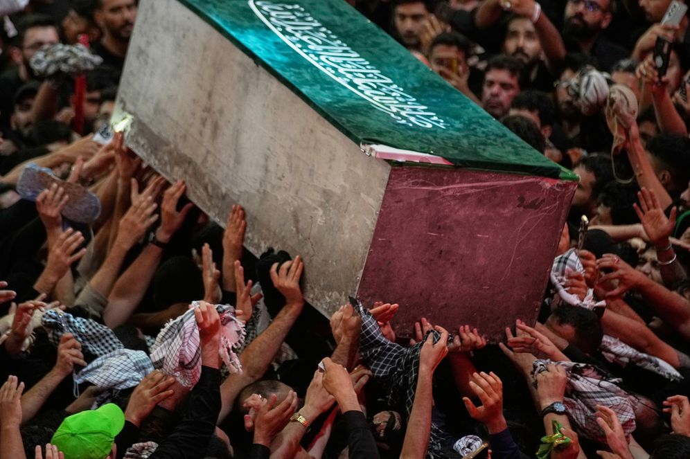 (AP Photo/Khalil Hamra) The coffin of the late Iranian Supreme Leader Ayatollah Ali Khamenei is carried through a crowd as mourners jostle to reach and touch it outside the Imam Hussein Shrine in Karbala, Iraq, early Thursday, July 9, 2026.