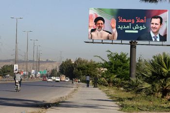 A billboard with pictures of Iranian President Ebrahim Raisi (L) and Syrian President Bashar al-Assad in Damascus, Syria.