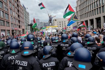 Police officers try to stop people taking part in a pro-Palestinian rally in Berlin, Saturday, May 18, 2024