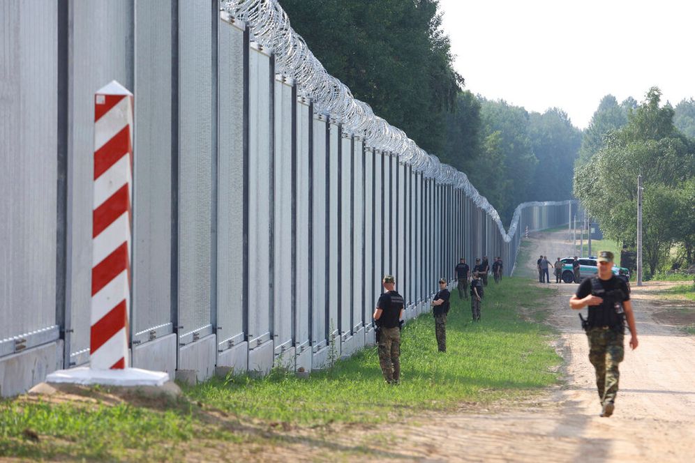 Polish border guards patrol the area of a newly built metal wall on the border between Poland and Belarus, near Kuznice, Poland, June 30, 2022.