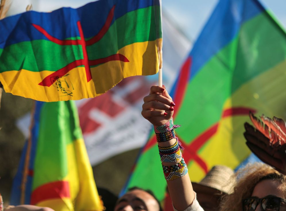 People raise flags of the Amazigh, indigenous people of Morocco.