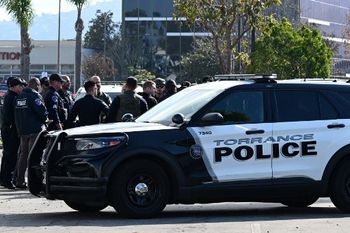 Torrance police officers and other law enforcement gather after breaking into a van with a body in the driver's seat in Torrance, California, on January 22, 2023. California police hunting the gunman who killed 10 people at a dance club during Lunar New Year celebrations broke into a van after a lengthy standoff Sunday, where images showed a body slumped in the driver's seat. The hunt began 12 hours earlier after a man -- described by police as Asian -- began firing at a club in Monterey Park, a city in Los Angeles County with a large Asian community.
