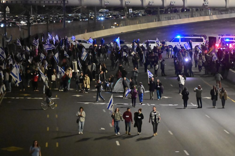 Israelis block the Ayalon Highway in Tel Aviv during a protest against the government's planned judicial overhaul.