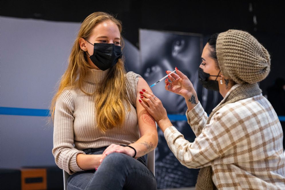 A young Israeli receives a dose of Covid-19 vaccine at the Malcha mall in Jerusalem on December 23, 2021.