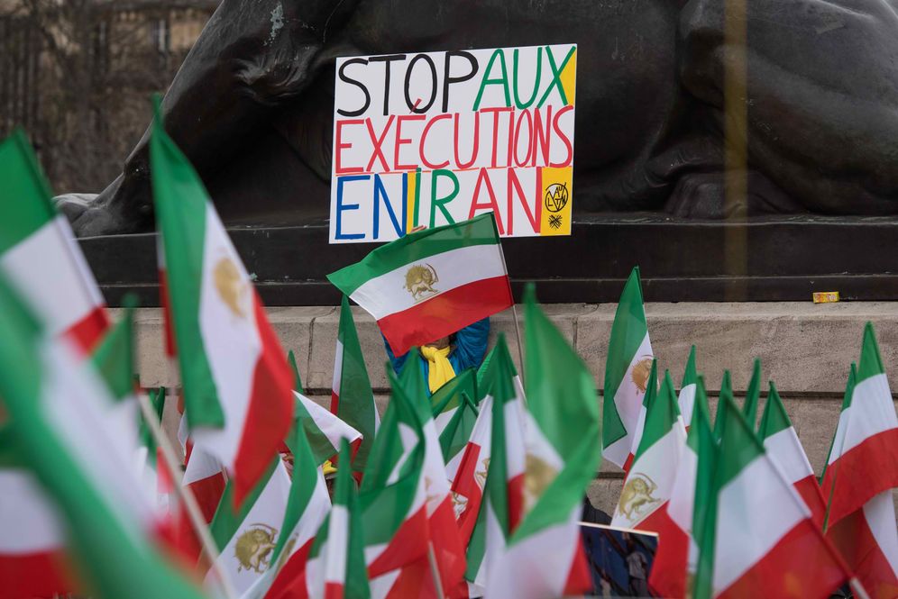 File photo of a demonstrator holding up a sign reading "Stop Executions in Iran" in France