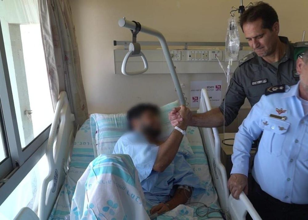 Israel Defense Forces (IDF) soldier that was wounded earlier on Monday, during an operation to arrest suspected terrorists in Jenin, shaking hands with Commander of Israel's Border Police Superintendent Amir Cohen (R).