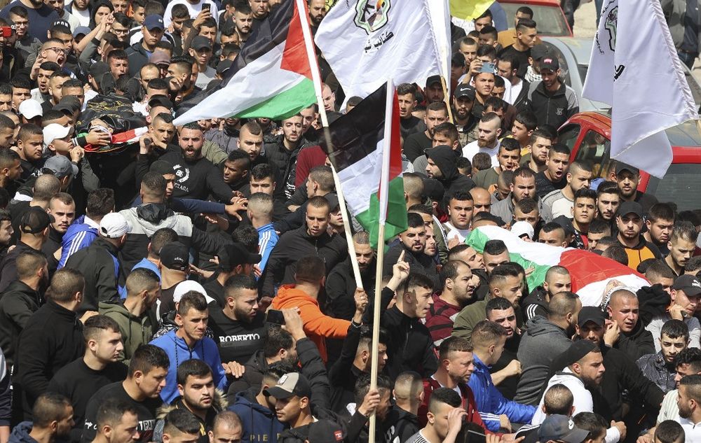 Palestinian mourners attend the funeral of Sanad Abu Atiyeh and Yazan al-Saadi in the town of Jenin on March 31, 2022 after they were killed during an Israeli raid in the West Bank.