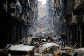 Residents walk through destruction in Aleppo, Syria.