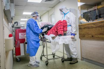 Kaplan hospital team members wearing safety gear as they work in the Coronavirus ward of Kaplan Medical Center in Rehovot on January 18, 2022.