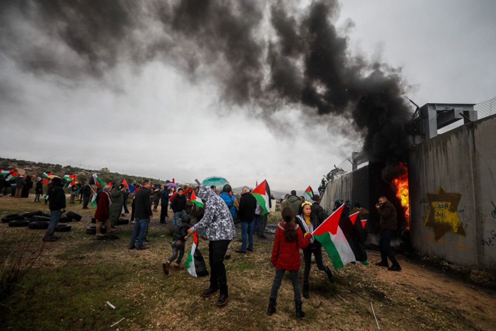 Flash90 Palestinians rioting near the separation barrier in the village of Bilin in the West Bank.