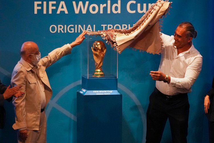 Tehran's city council chairman Mehdi Chamran (L) and former Iranian national soccer team captain Ahmad Reza Abedzadeh reveal the FIFA World Cup trophy at Milad Tower hall in Tehran, Iran, on September 1, 2022.