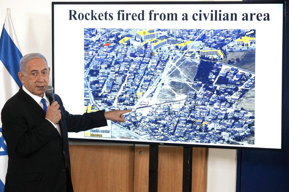 Israel's Prime Minister Benjamin Netanyahu gestures as he shows a slideshow during a briefing to ambassadors to Israel at the Hakirya military base in Tel Aviv, on May 19, 2021.