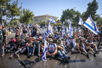 Anti-overhaul activists block a road during a protest against the government's judicial reform, near the Knesset, the Israeli parliament in Jerusalem.