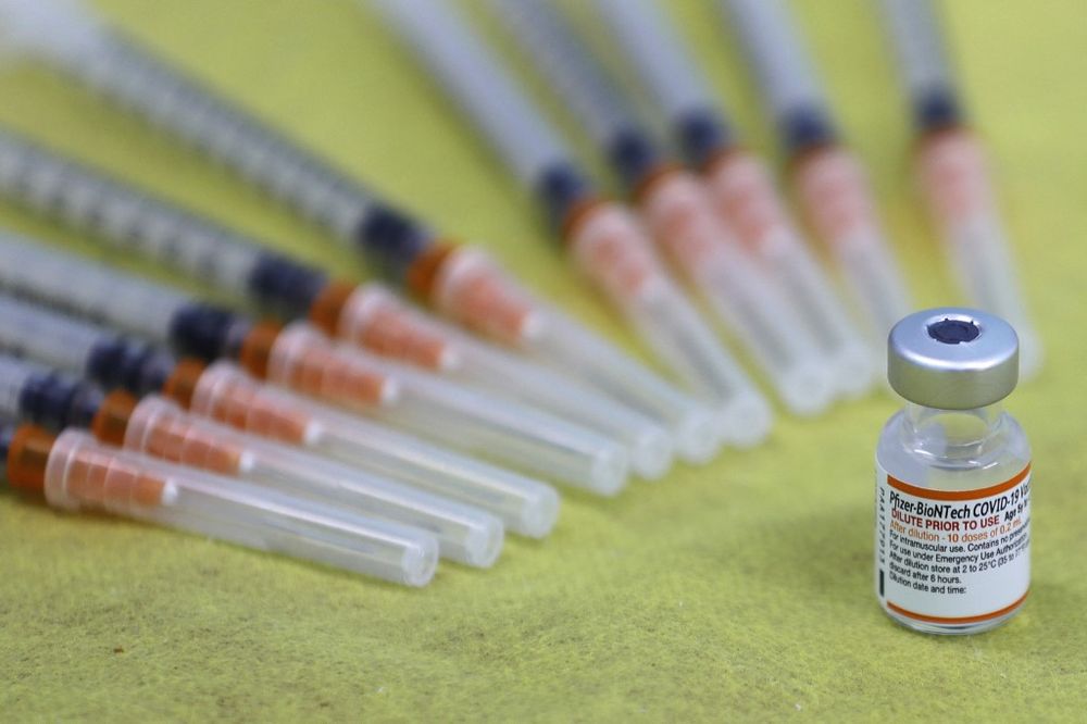 A picture shows a vial of the Pfizer/BioNTech Covid vaccine during a vaccination drive at the al-Manahel School in the Druze village of Majdal Shams in the Golan Heights, on December 12, 2021.