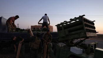 Members of Syria's security forces load a rocket in an area between Mazraa and Walga near the predominantly Druze city of Sweida on July 14, 2025.