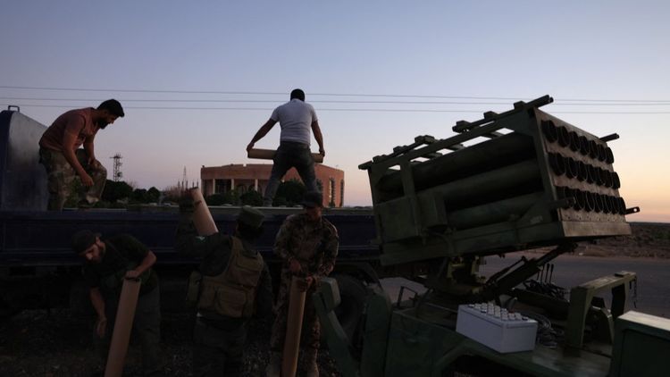 Members of Syria's security forces load a rocket in an area between Mazraa and Walga near the predominantly Druze city of Sweida on July 14, 2025.