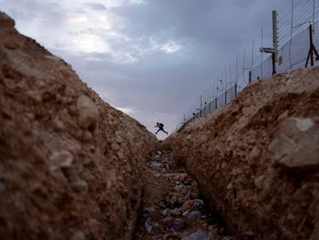A Palestinian crosses into Israel from the West Bank through an opening in the Israeli separation barrier.