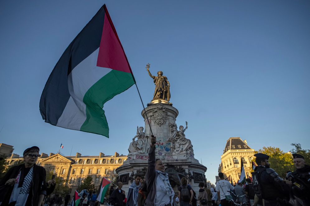 A woman holds a Palestinian flag during a pro-Palestinian gathering at Republic square in Paris, Wednesday, Sep. 17, 2025. 

