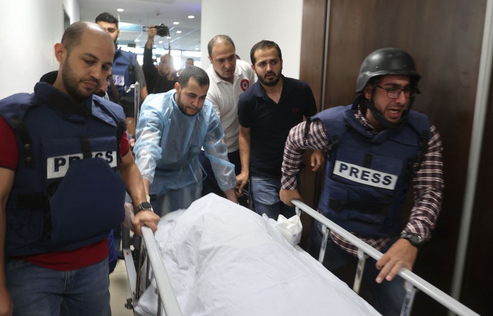 Journalists escort the body of Shireen Abu Aqleh, who was killed in the West Bank refugee camp of Jenin on May 11, 2022, to the Jenin hospital.