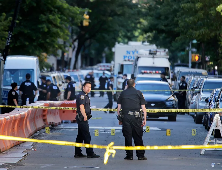 FILE - Numbers mark a crime scene near the site where a police officer was fatally shot in the Bronx section of New York, Wednesday, July 5, 2017