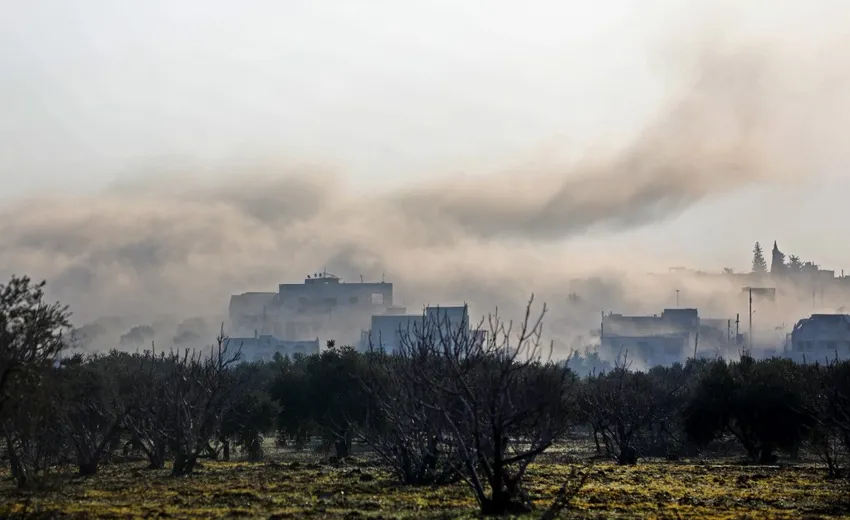 Smoke billows above buildings during an air strike by pro-regime forces on the village of Nayrab, about 14 kilometres southeast of the city of Idlib in northwestern Syria on February 25, 2020.