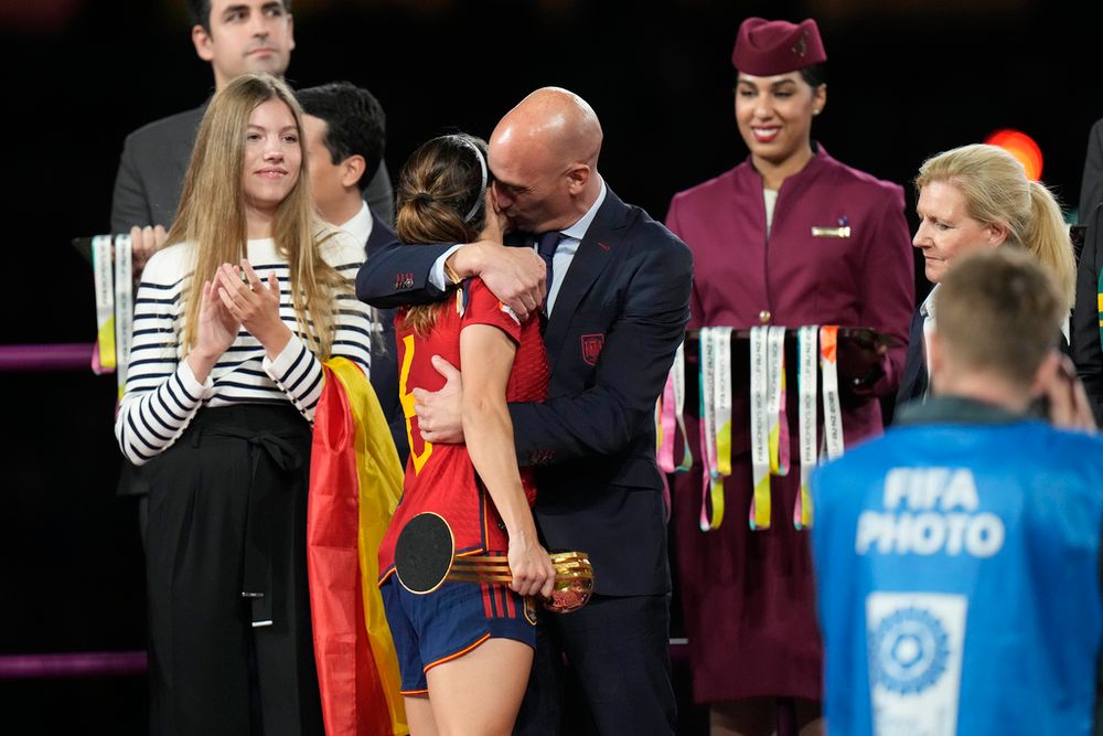 President of Spain's soccer federation, Luis Rubiales, right, hugs Spain's Aitana Bonmati on the podium following Spain's win in the final of Women's World Cup soccer against England at Stadium Australia in Sydney, Australia.