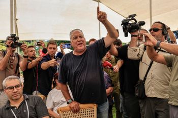 Eyal Eshel, father of IDF observer Roni Eshel protest against Israeli Finance Minister Bezalel Smotrich during a ceremony for the construction of 1,000 new housing units in Kibbutz Ein Hashlosha, near the Israeli border with the Gaza Strip, southern Israel, June 29, 2026. 
